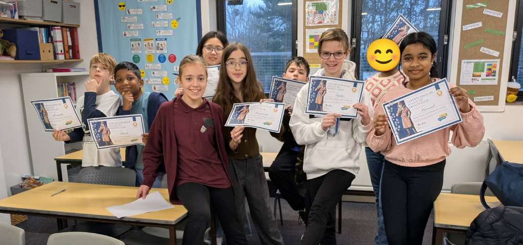 Proud children holding their French certificates
